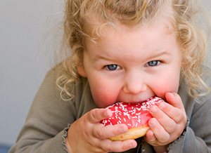 Übergewichtiges Mädchen isst Donut