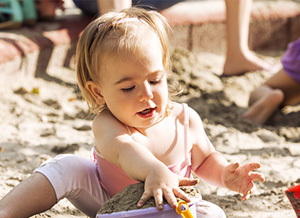 Mädchen spielt im Sand